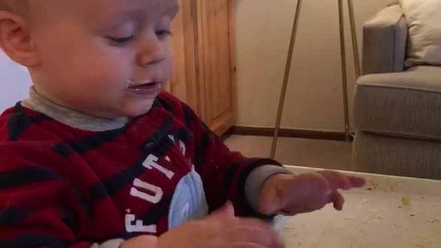 Little kid black and red striped shirt playing games on phone