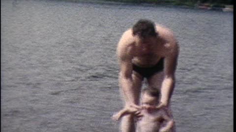 09/1959 Tom swimming at Deer Lake / Newly varnished boat