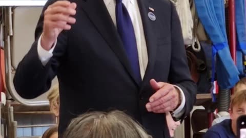 Biden wears A Trump hat