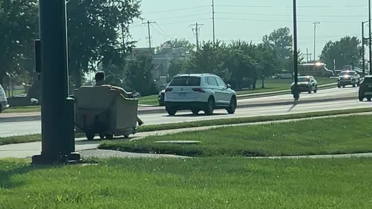 Man Rides Motorized Recliner on Sidewalk