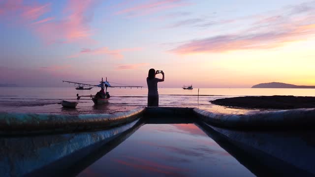 Woman Takes A Photo Of Sunrise View With Smartphone