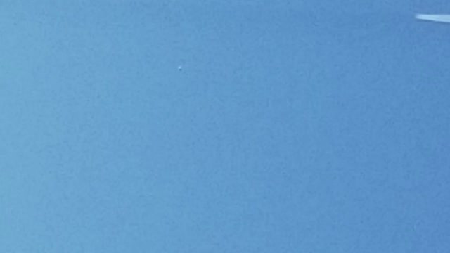 Crack in the sky with a chemtrail being laid down along its path.