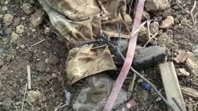 Ukrainian war [2022]. Dead Russian POW has tied legs and pierced hands.