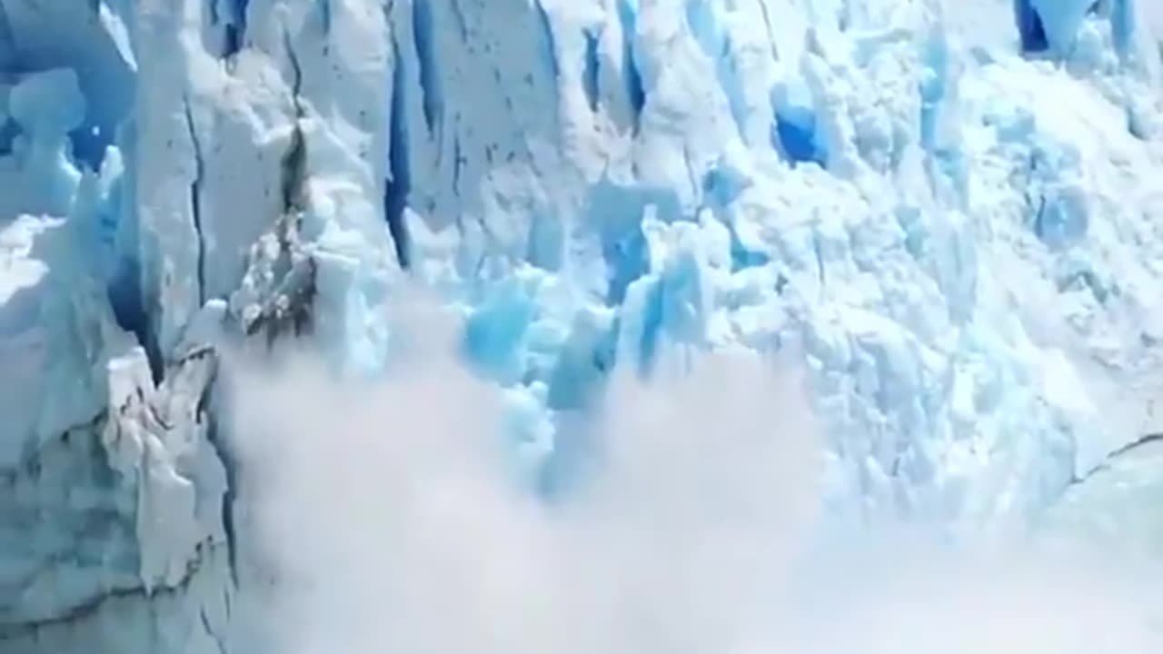 This Is Perito Moreno Glacier In Argentina the large arch of blue and white ice thunderously collapses into the glacial Lake Argentino below~In March People Come To View the spectacular Rupture