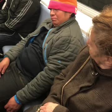Green jacket yellow beanie man falling asleep on woman