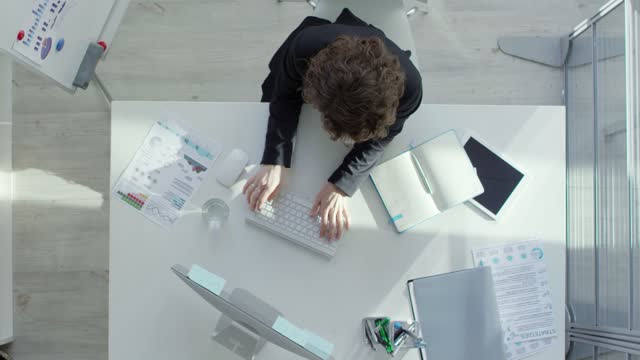 A Person Working On A Computer In An Office