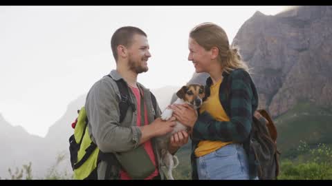 Caucasian couple with their dog in nature