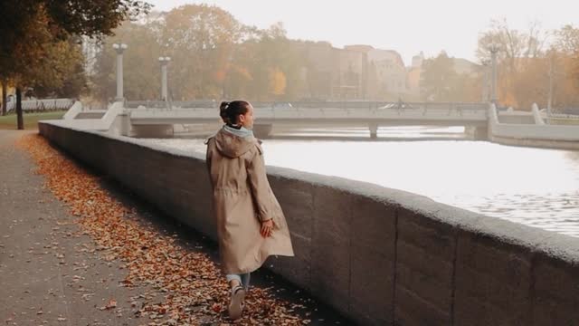 woman walking over the dried eaves by- the-river