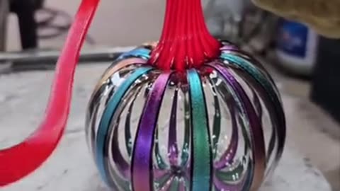 Creating pumpkins out of hot molten glass