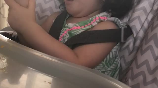 Trying to feed her Mango