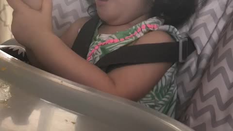 Trying to feed her Mango