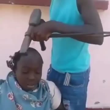 BUHARI BROTHER BARBING HAIR WITH IRON