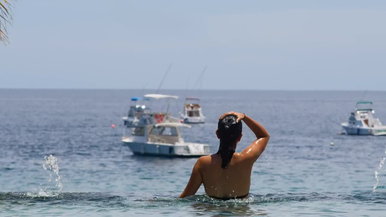 Woman swimming in ocean pool