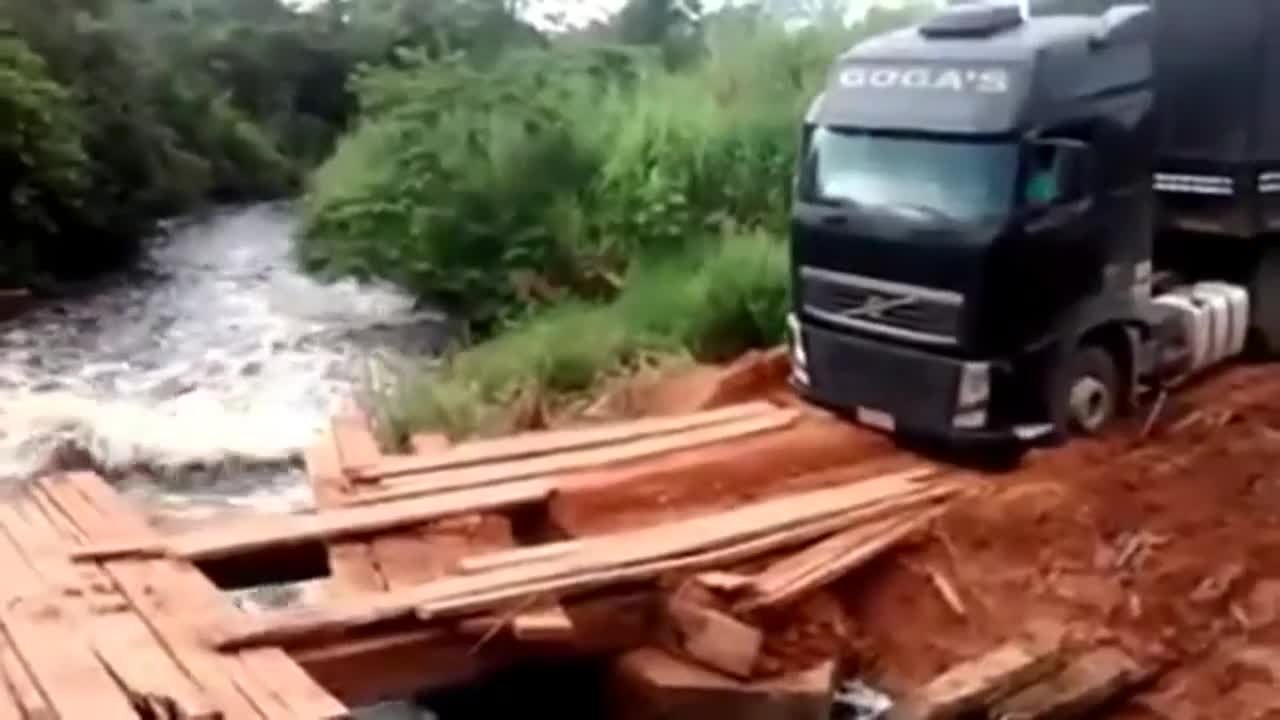 Trucker woman crossing precarious wooden bridge.