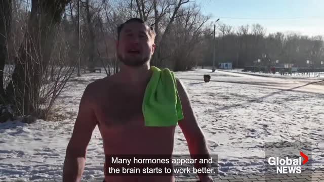 Siberian enthusiasts plunge into ice-cold river to kick off winter swimming season