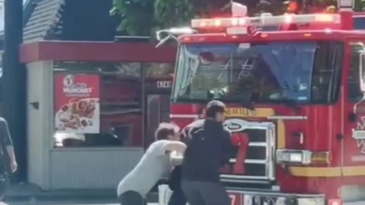 Man pushes idiot blocking a firetruck