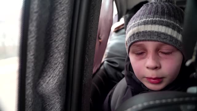 'We left our Dad in Kyiv' -little boy chokes back tears