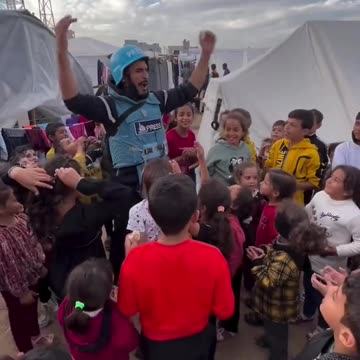 Children in a refguee camp as they chant "Free Palestine",