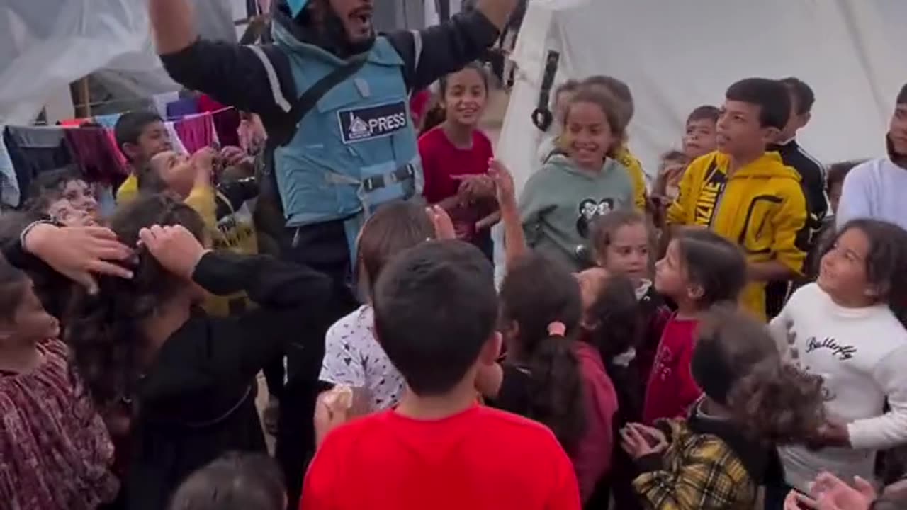 Children in a refguee camp as they chant "Free Palestine",