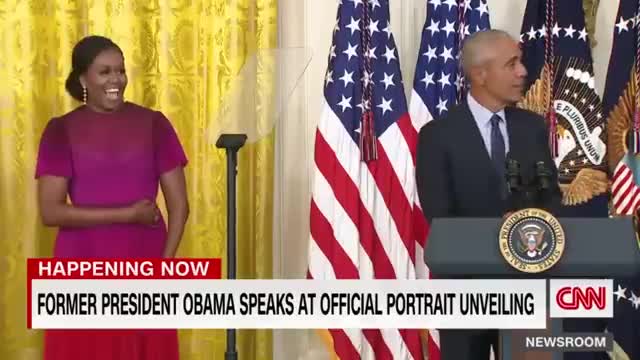 Barack Obama gives a speech after the unveiling of his White House portrait