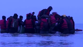 Migrants leave for England from a French beach