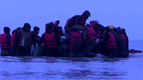 Migrants leave for England from a French beach