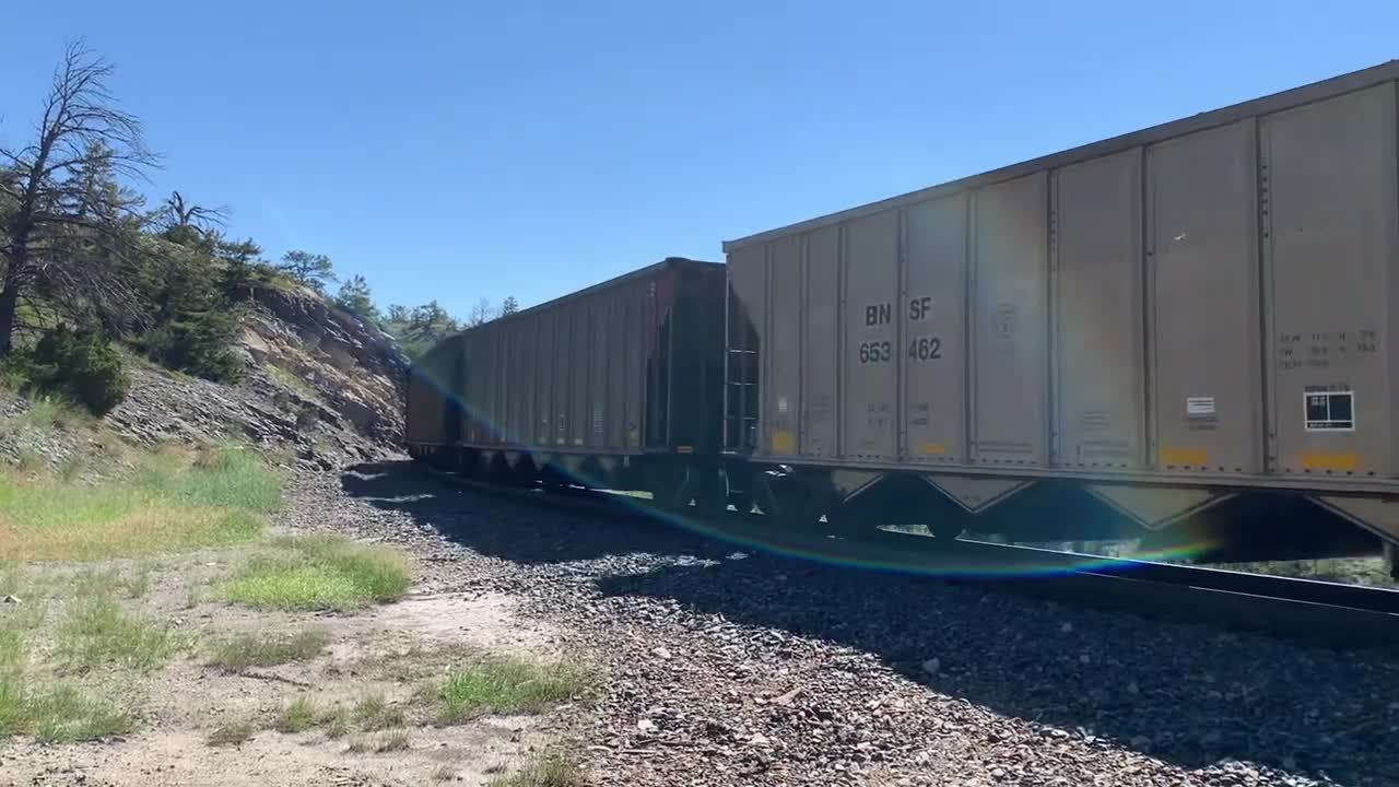 Solid EMD SD70ACe lineup up Mullan Pass. 3 BNSF, 4 MRL, then 1 BNSF on the rear.