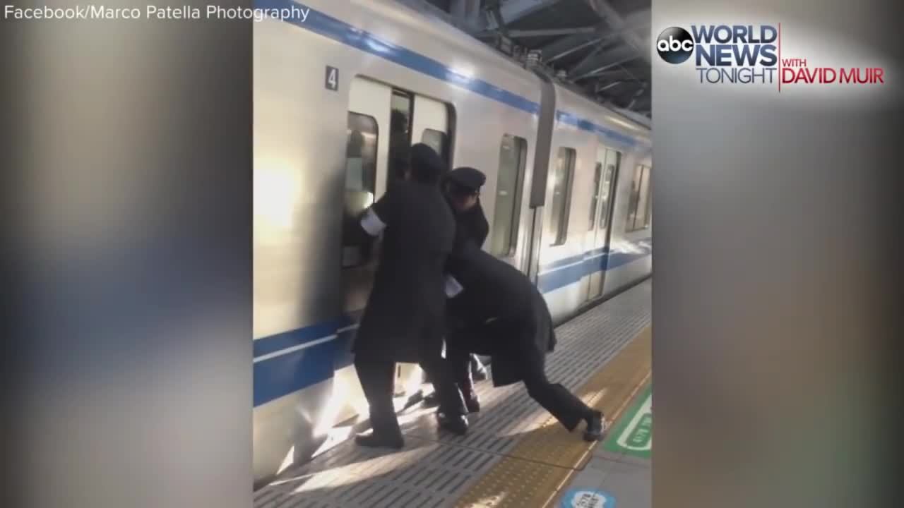 Professional Pushers Shove Passengers Onto Busy Tokyo Train