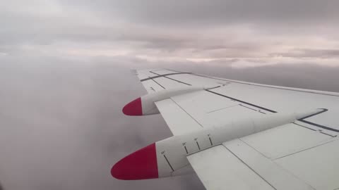 Qantaslink Fokker 100 climbing through clouds