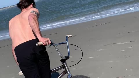 Cyclist Moonwalks on the Beach