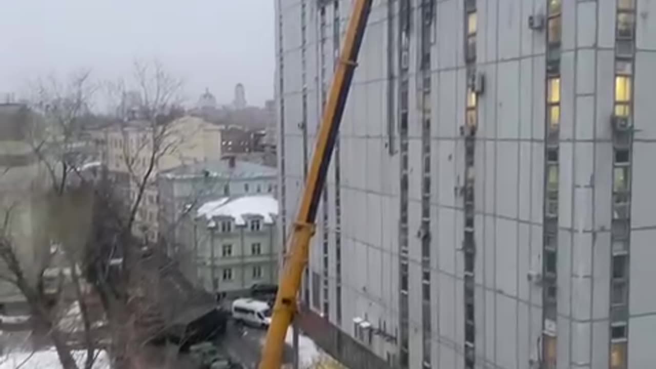 Using a Crane to Place a Panstar Mobile SAM On Top of High Rise Building in Moscow