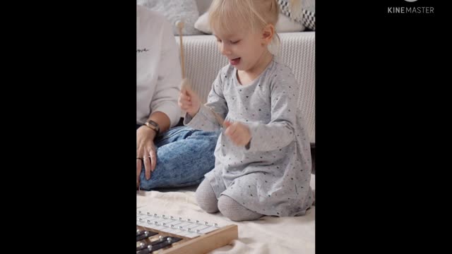 Toddler playing a musical instrument,