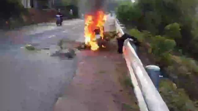 Tragic motorcycle accident on the road emitting smoke