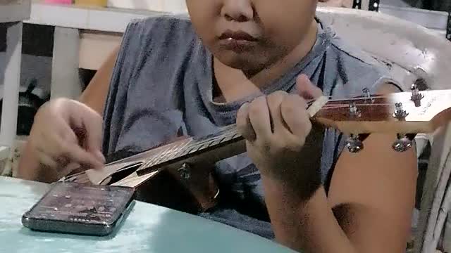 My son playing ukelele