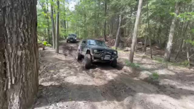 Ram and Jeeps cross shallow mud hole