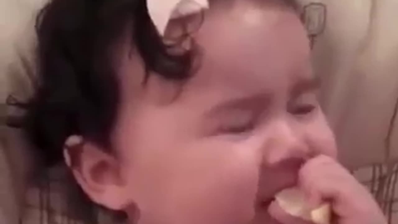 Babies eating a lemon for the first time