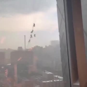 Several glass maintenance workers in China trapped hanging from building