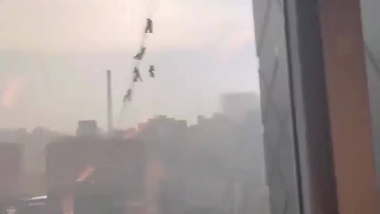 Several glass maintenance workers in China trapped hanging from building