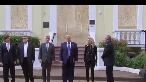 The President walks across Lafayette Park to St. John's Church. Holding a Bible