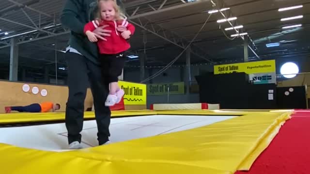 Dad Performs Backflip on Trampoline While Holding his Toddler in his Arms