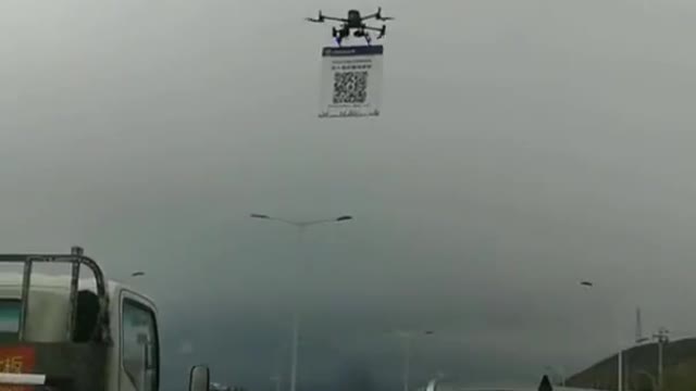 China:a police drone comes towards you on the highway, quickly scans your QR code