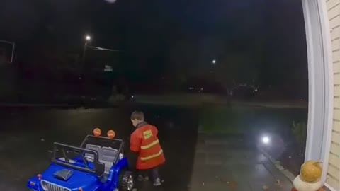 Kid driving his little car to trick or treat