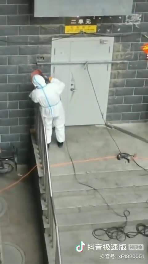 The government is welding the entrance door to the apartment building to enforce the lockdown
