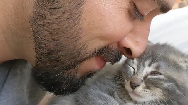 Meet Aiko, the runt if her litter. She was crying until he started doing this.