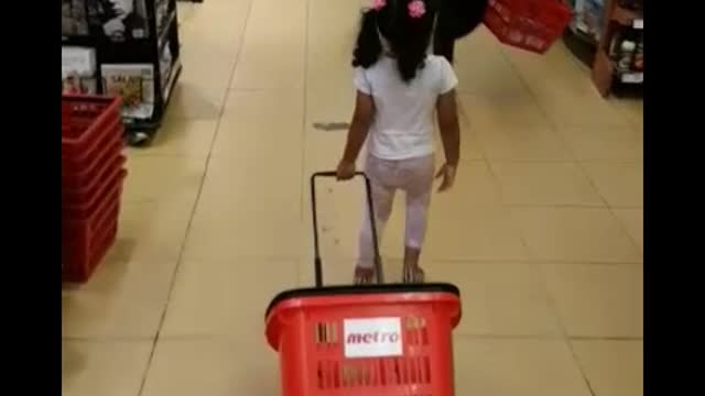 Toddler doing grocery shopping