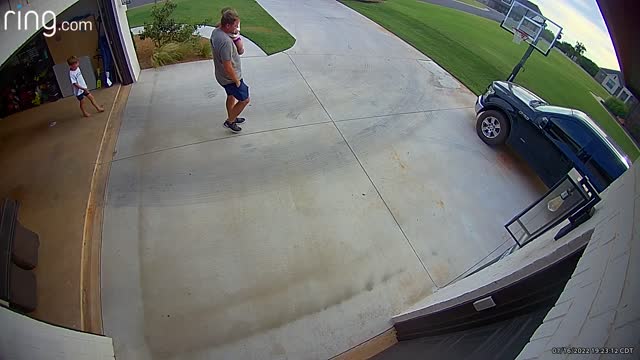 Little Girl Hangs on to Opening Garage Door