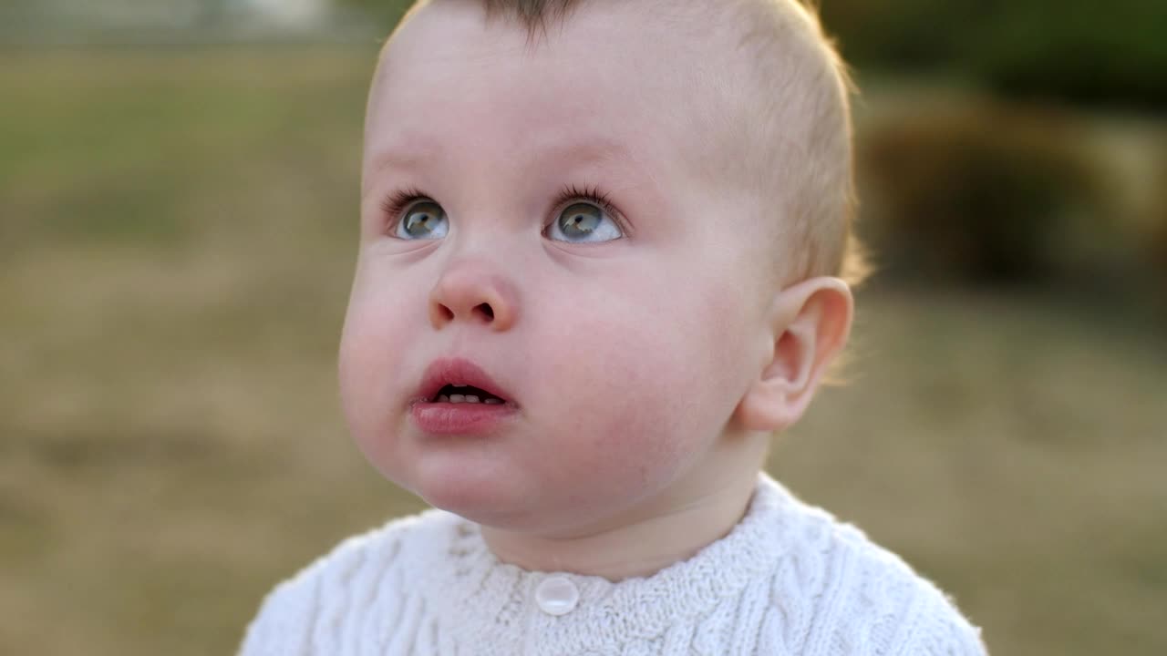 Little baby looking up at the sky, portrait