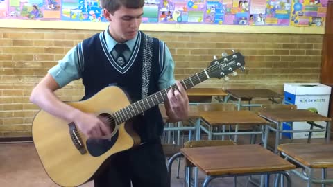 A very talented guitar player! Just showing a trick he mastered.