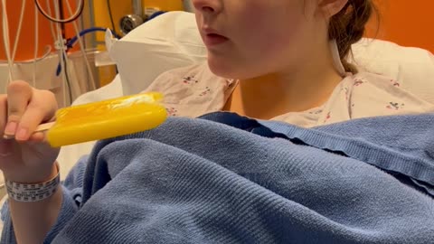 Girl Recovering From Surgery Takes a Bite Out of a Popsicle