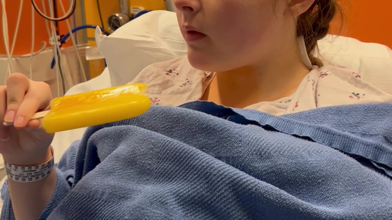 Girl Recovering From Surgery Takes a Bite Out of a Popsicle
